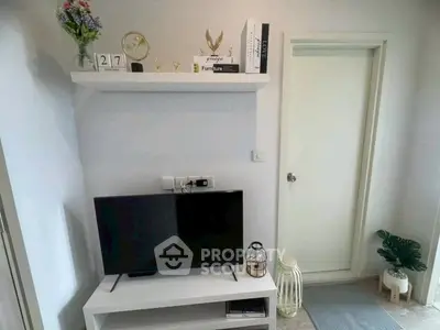 Modern living room with stylish decor and flat-screen TV, showcasing contemporary interior design.