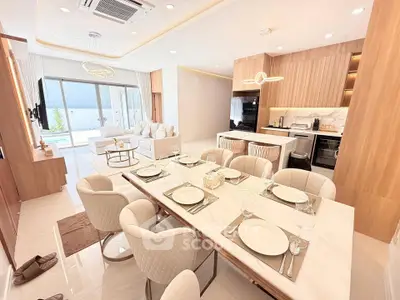 Luxurious open-plan living and dining area with modern kitchen in elegant apartment