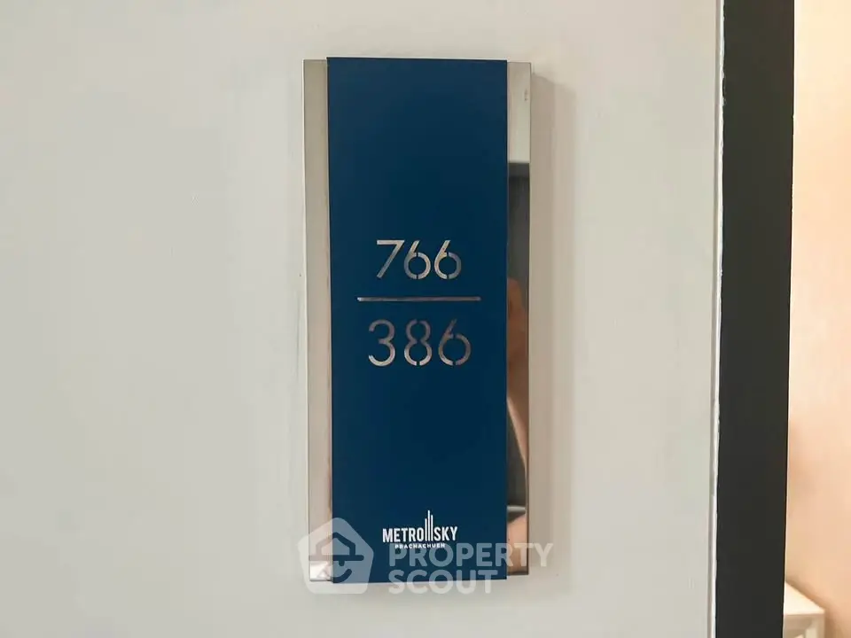 Modern apartment door number sign with sleek design at Metro Sky Pracachuen.