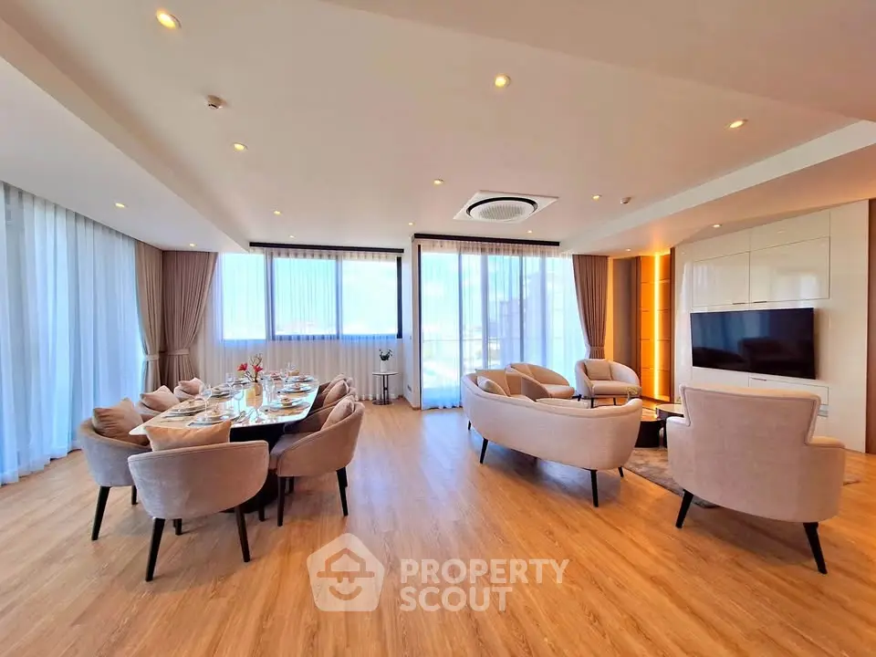 Spacious modern living room with elegant dining area and panoramic windows
