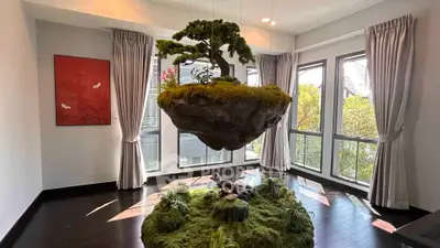Stunning modern living room with floating bonsai and large windows