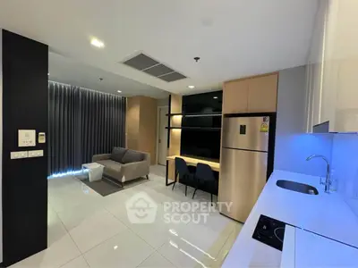 Modern open-layout living room with sleek kitchen and cozy seating area
