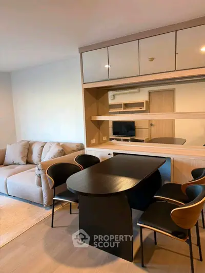 Modern living room with stylish furniture and built-in storage, perfect for urban living.