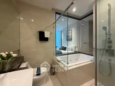 Luxurious bathroom with modern design and glass shower enclosure in upscale apartment.