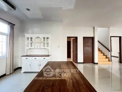 Spacious interior with elegant wooden furniture and staircase in modern home