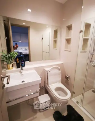Modern bathroom with sleek fixtures and glass shower enclosure