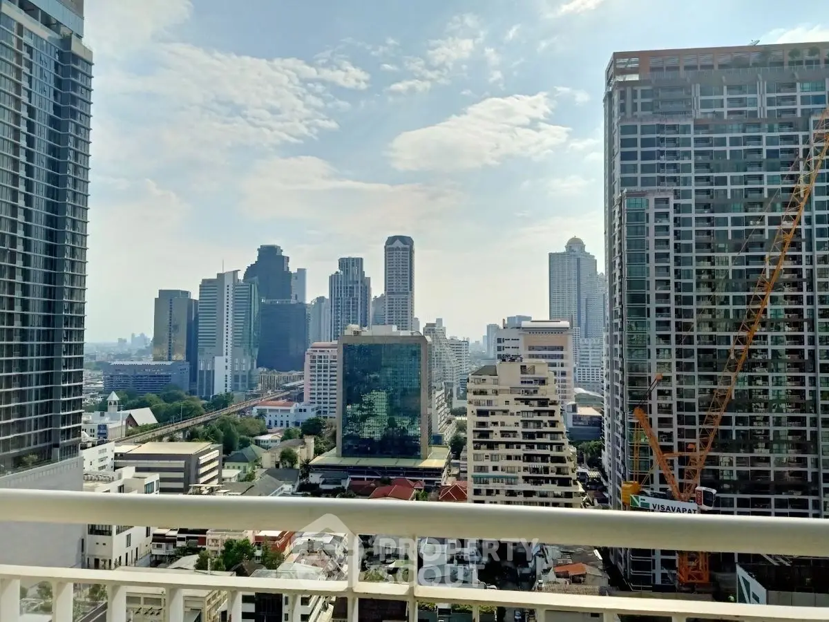 Stunning cityscape view from high-rise balcony in urban skyline.