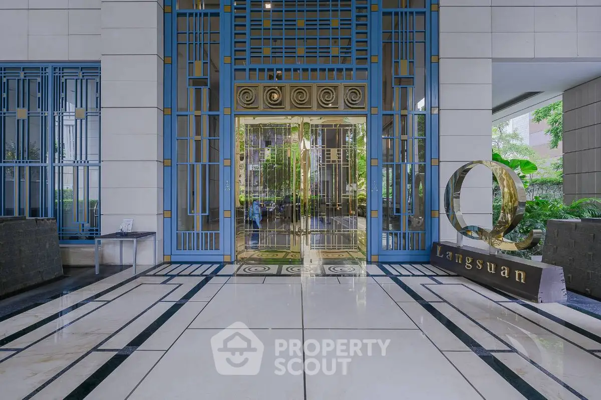 Luxurious building entrance with elegant design and lush greenery at Langsuan.
