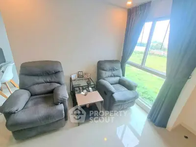 Cozy living room with plush recliners and scenic window view