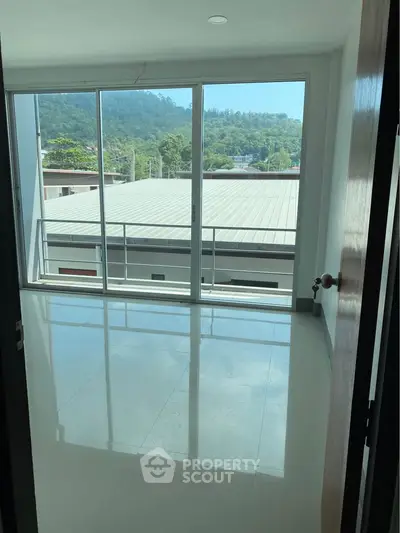 Spacious room with large windows offering stunning mountain views and abundant natural light.