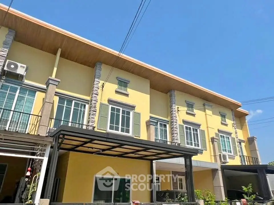 Charming yellow townhouse with modern design and ample natural light