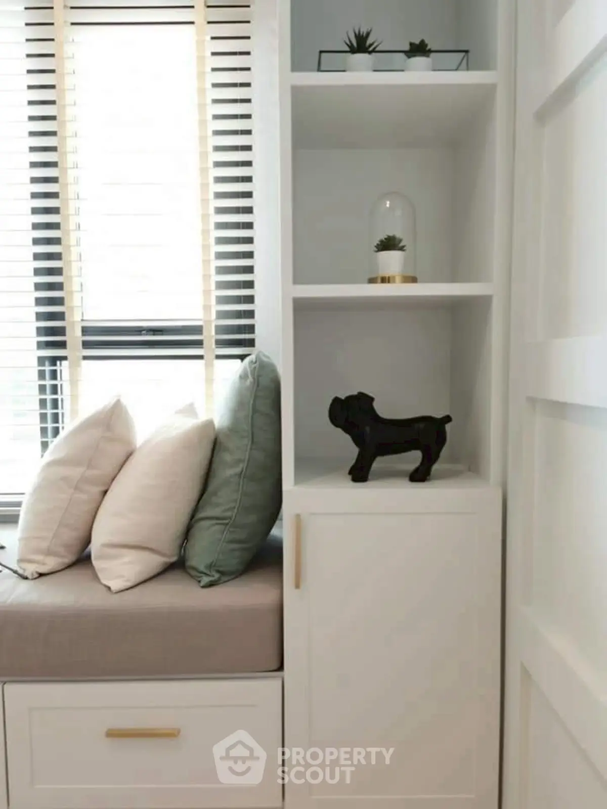 Chic modern living room corner with stylish decor and cozy seating by the window.