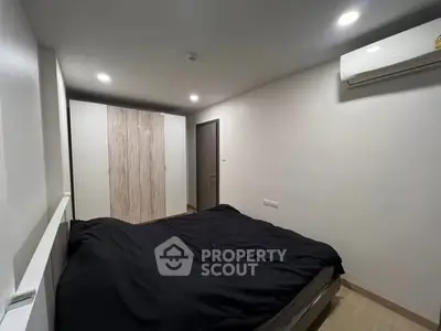 Modern bedroom with sleek design and air conditioning in a stylish apartment.