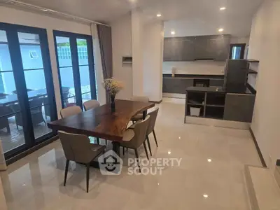 Modern open-plan kitchen and dining area with sleek design and natural light.