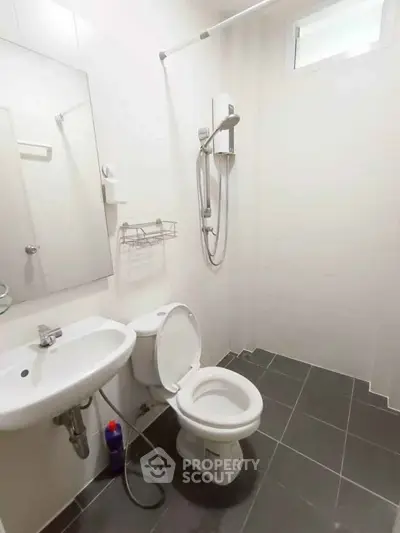 Modern bathroom with sleek fixtures and a shower in a contemporary home.