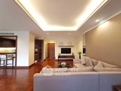 Spacious living room with elegant decor and cozy seating in a modern apartment.