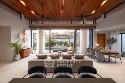 Luxurious open-plan living room with pool view and elegant dining area