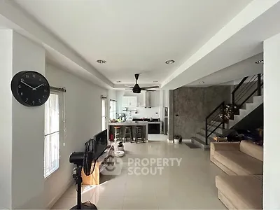 Spacious open-plan living room with modern kitchen and stylish decor