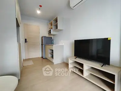 Modern studio apartment with sleek interior design and compact kitchen area