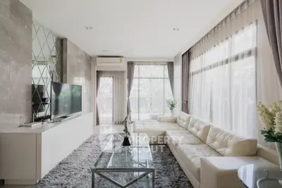 Luxurious living room with modern decor and large windows for natural light.