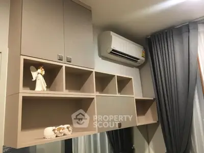 Modern living room with stylish shelving and air conditioning unit