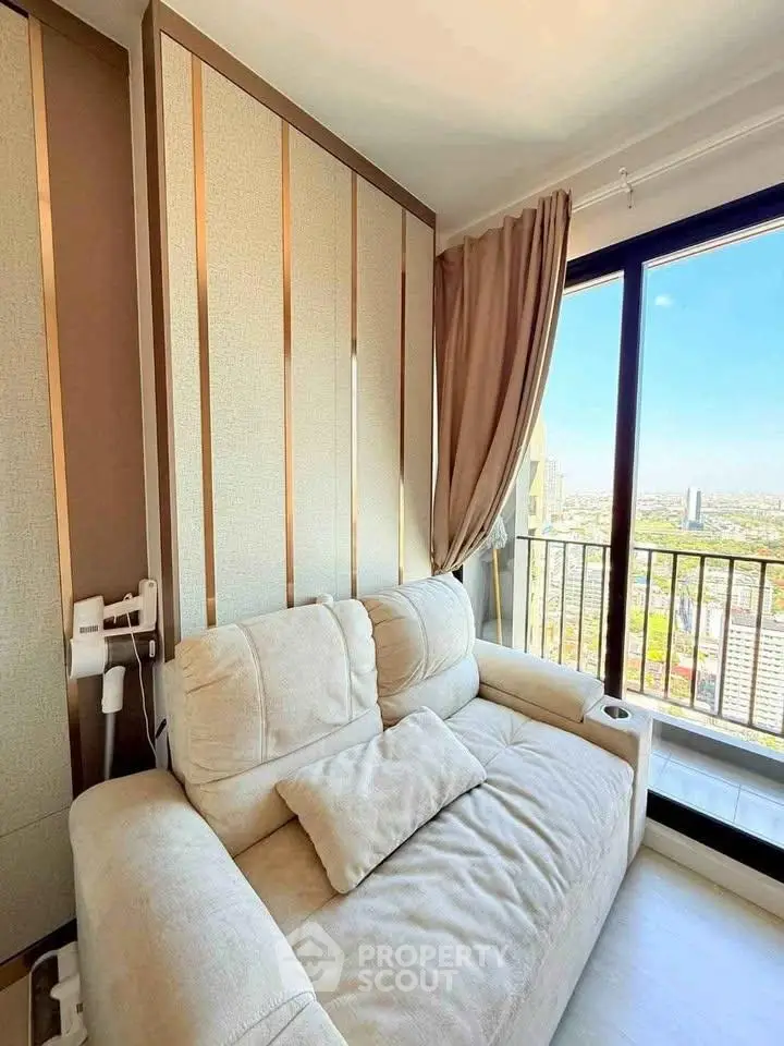 Modern living room with cozy sofa and stunning city view from balcony.