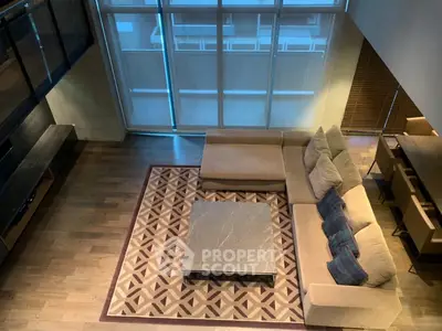 Spacious modern living room with large windows and stylish furniture