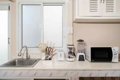 Modern kitchen with sleek appliances and ample counter space, perfect for culinary enthusiasts.