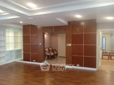 Spacious modern living room with wooden flooring and elegant ceiling lights