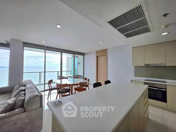 Spacious open-plan living room with ocean view and modern kitchen