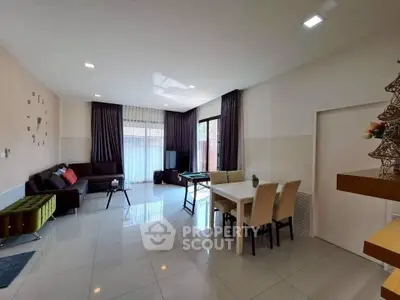 Spacious modern living room with elegant decor and ample natural light.