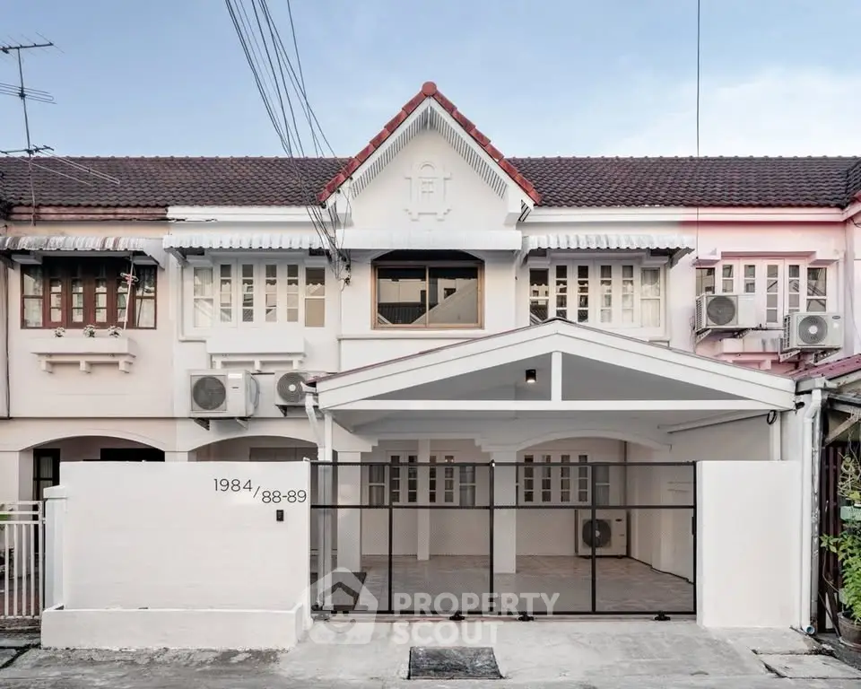 Charming townhouse with modern facade and spacious driveway in a serene neighborhood.