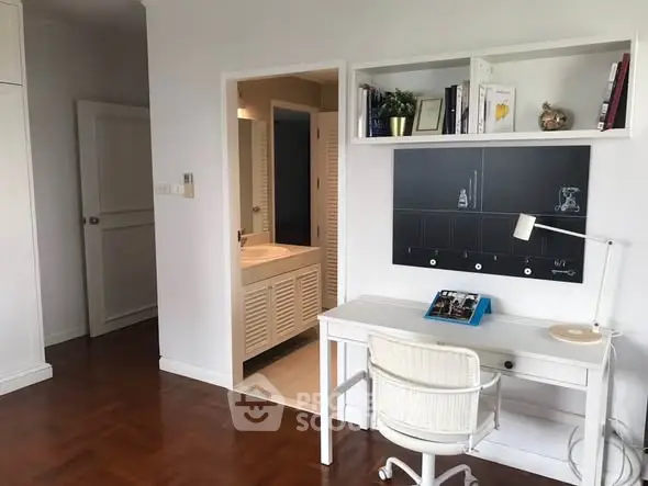 Chic study area with modern desk and shelving in a stylish home interior.