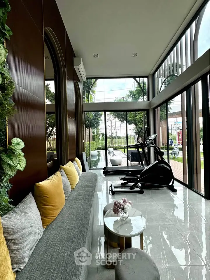 Luxurious home gym with modern equipment and garden view, perfect for fitness enthusiasts.