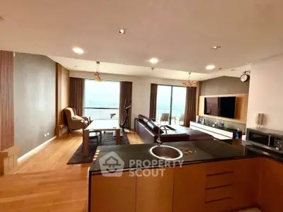 Spacious modern living room with open kitchen and stunning city view