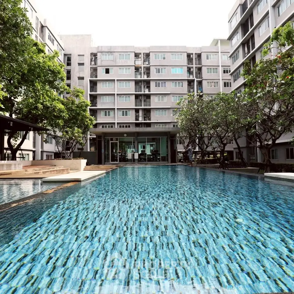 Luxurious condominium with a stunning outdoor pool and modern architecture.