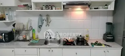 Cozy kitchen with modern appliances and sleek white cabinetry