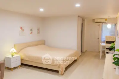 Spacious bedroom with modern decor and cozy ambiance, featuring a comfortable bed and stylish furnishings.