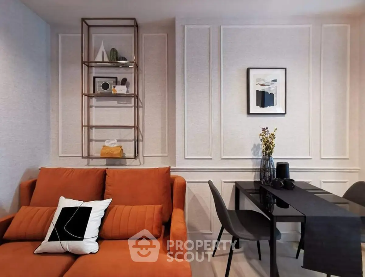 Stylish modern living room with orange sofa and elegant dining area, perfect for urban living.