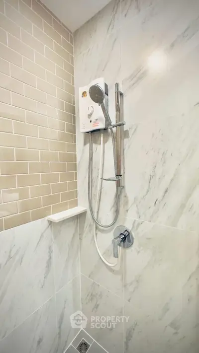 Modern bathroom shower with marble tiles and sleek fixtures