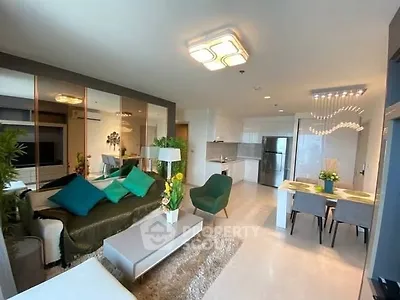 Modern open-plan living room with stylish decor and kitchen area