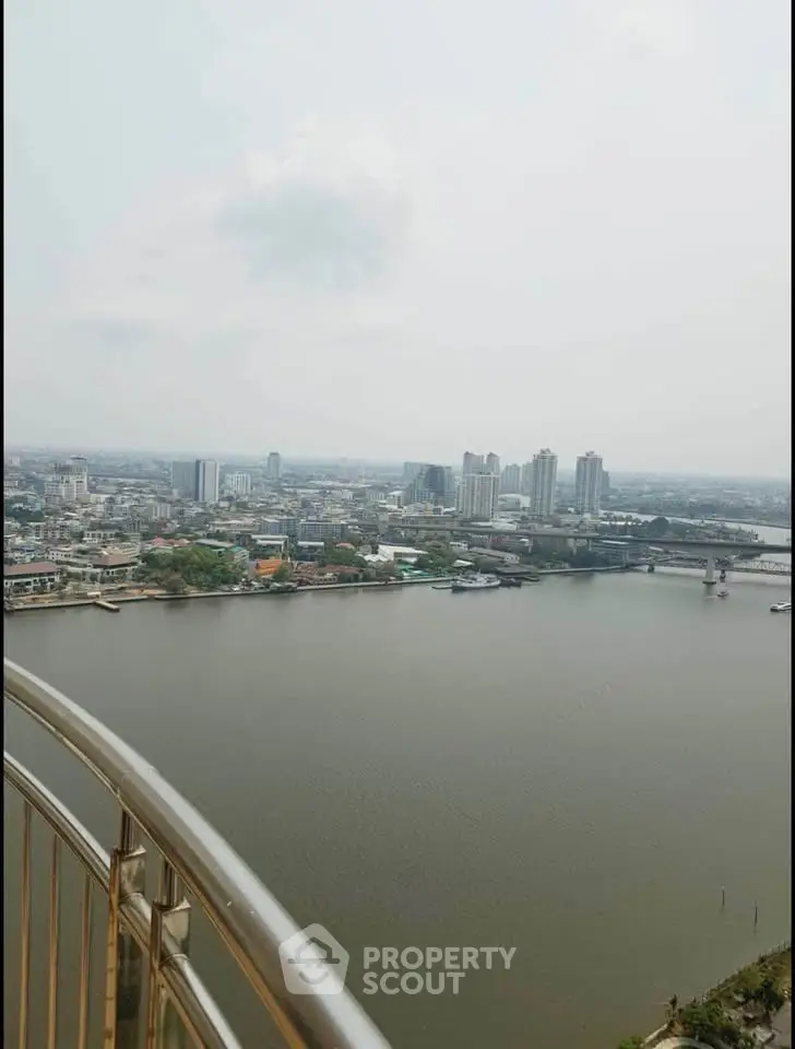 Stunning river view from high-rise balcony with cityscape backdrop, perfect for urban living enthusiasts.
