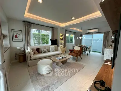Spacious modern living room with elegant decor and large windows offering natural light.