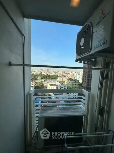 High-rise balcony with city view and air conditioning unit, perfect for urban living.