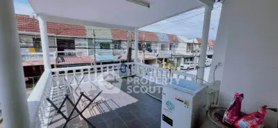 Spacious balcony with laundry area and street view in residential neighborhood.