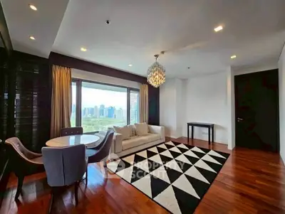Spacious living room with city view, elegant chandelier, and modern decor