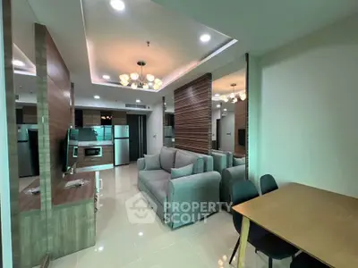 Modern living room with open kitchen, stylish furniture, and elegant lighting in a contemporary apartment.