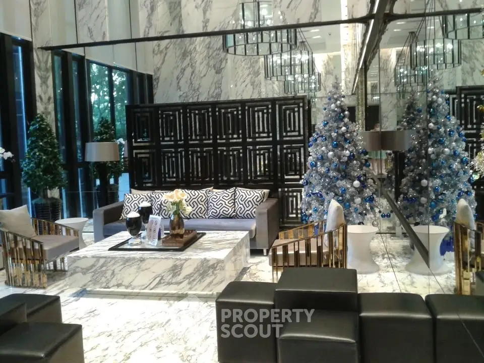 Luxurious lobby with elegant marble decor and festive Christmas trees
