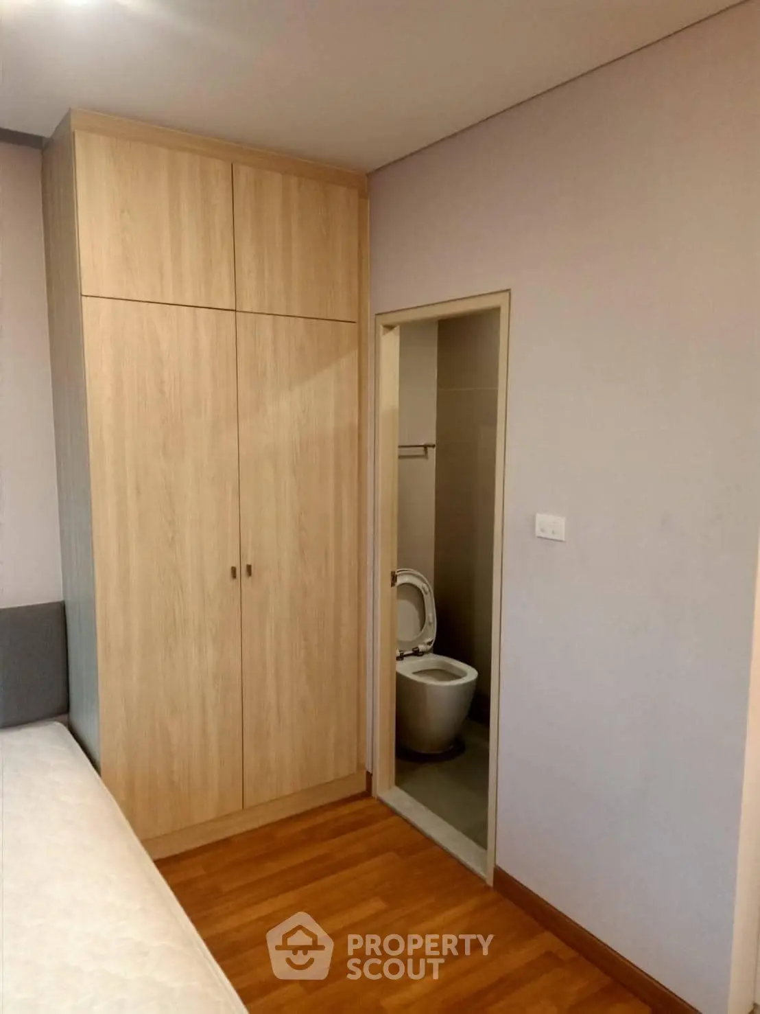 Cozy bedroom with wooden wardrobe and ensuite bathroom