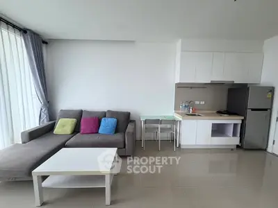 Modern living room with sleek kitchen and cozy sofa in bright apartment